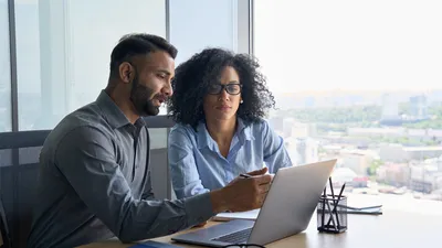 Coworkers in front of laptop