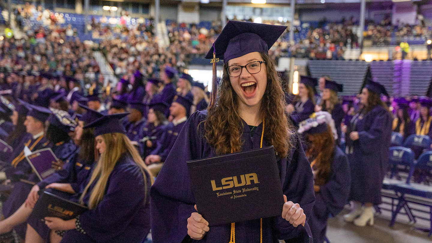 Graduate happily holding degree