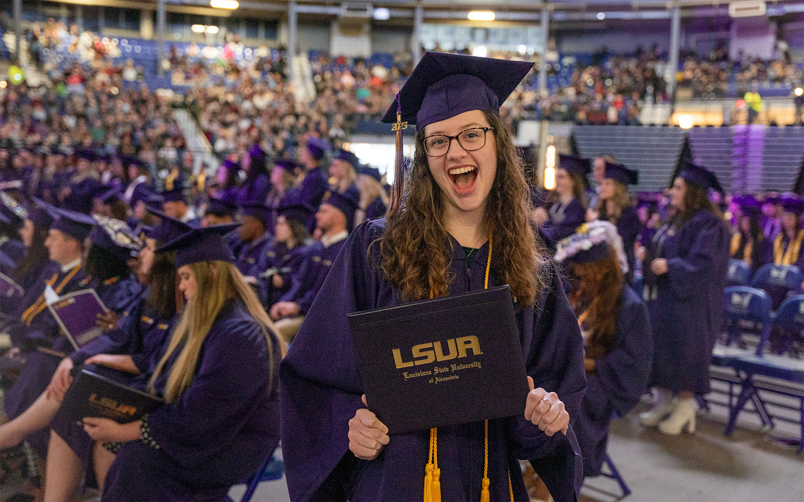 Graduate happily holding degree