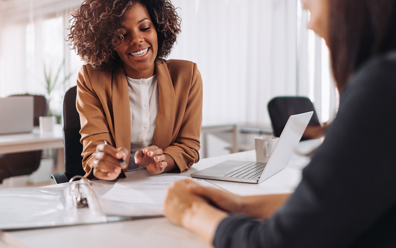 Financial analysts talking to another woman