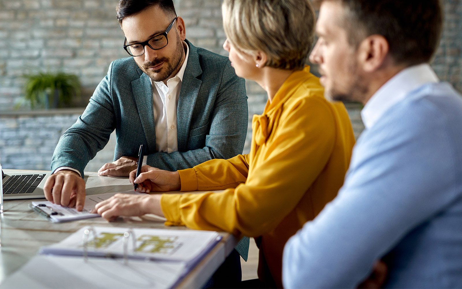 Real Estate agent speaking with a couple