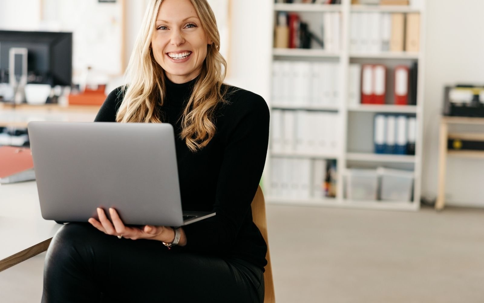 Professional woman holding laptop