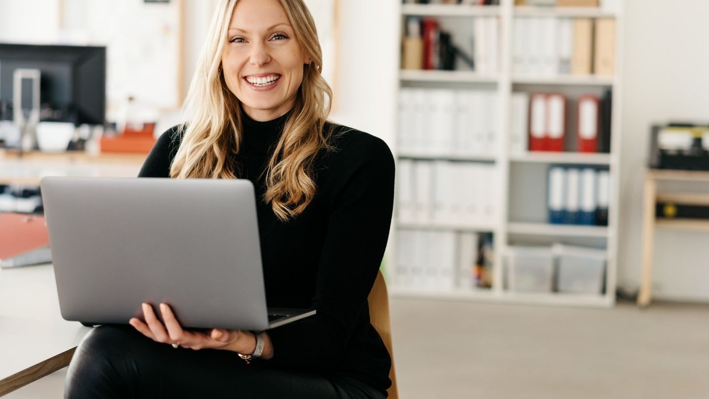 Professional woman holding laptop