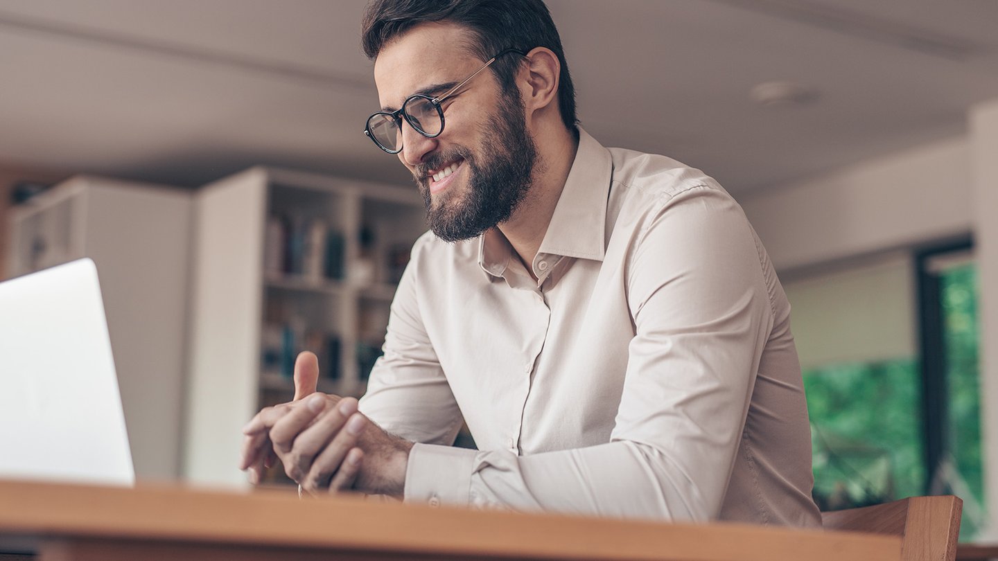 Man on laptop in online meeting