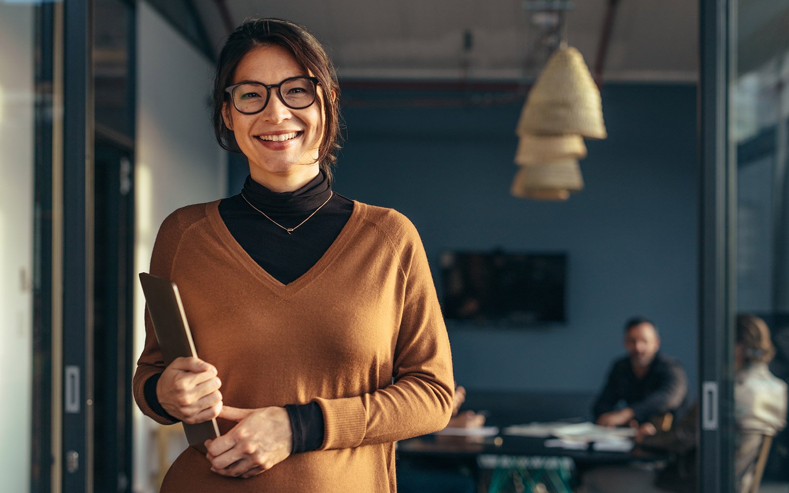 Woman holding a tablet smiling