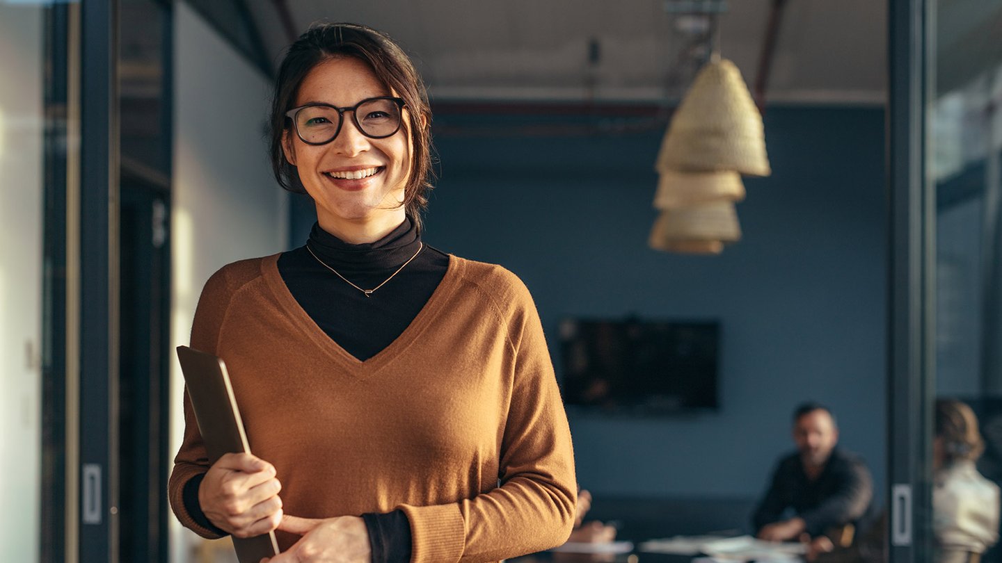 Woman holding a tablet smiling
