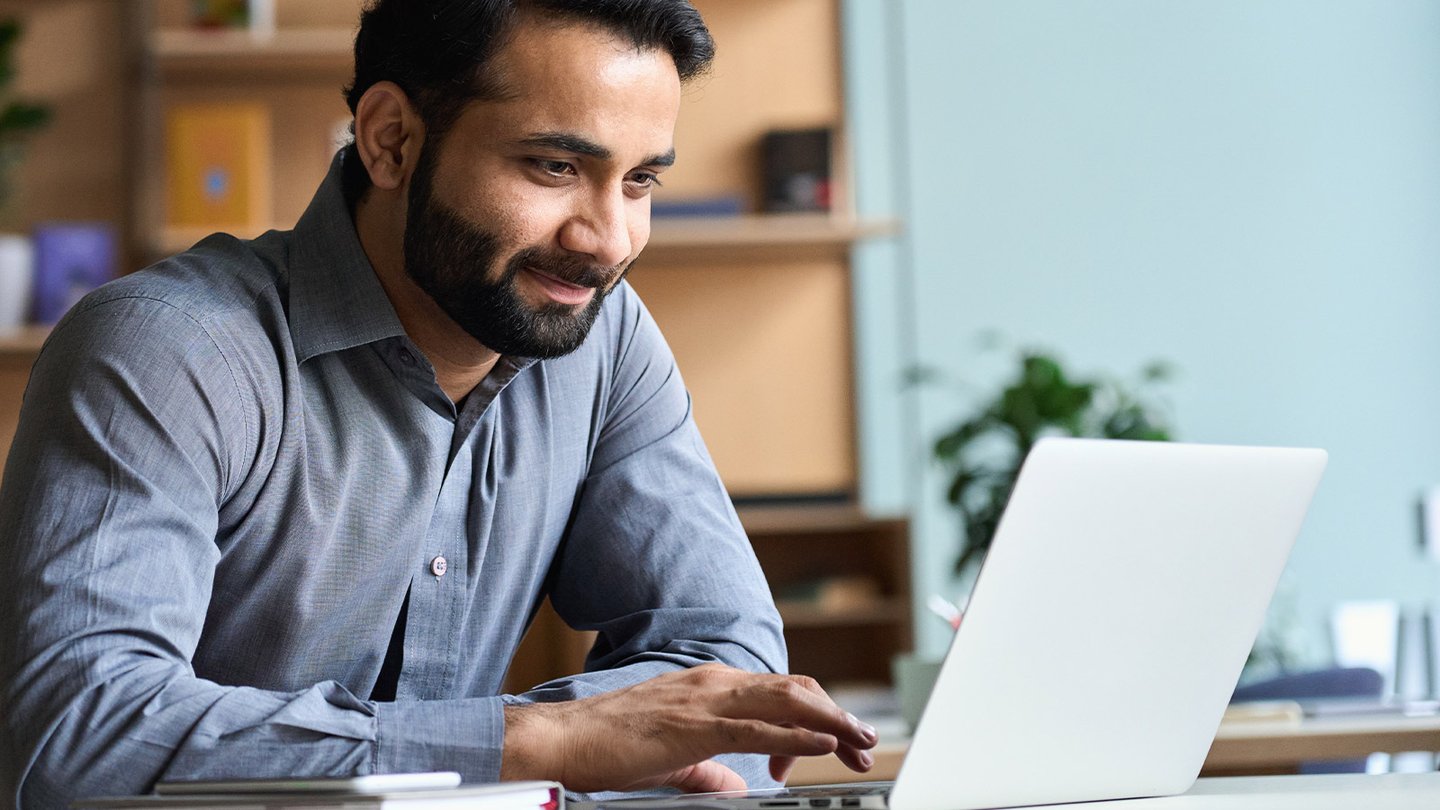 Man scrolling on his laptop