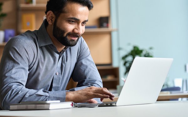 Man scrolling on his laptop