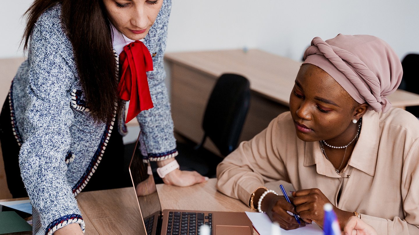 teacher working with a student