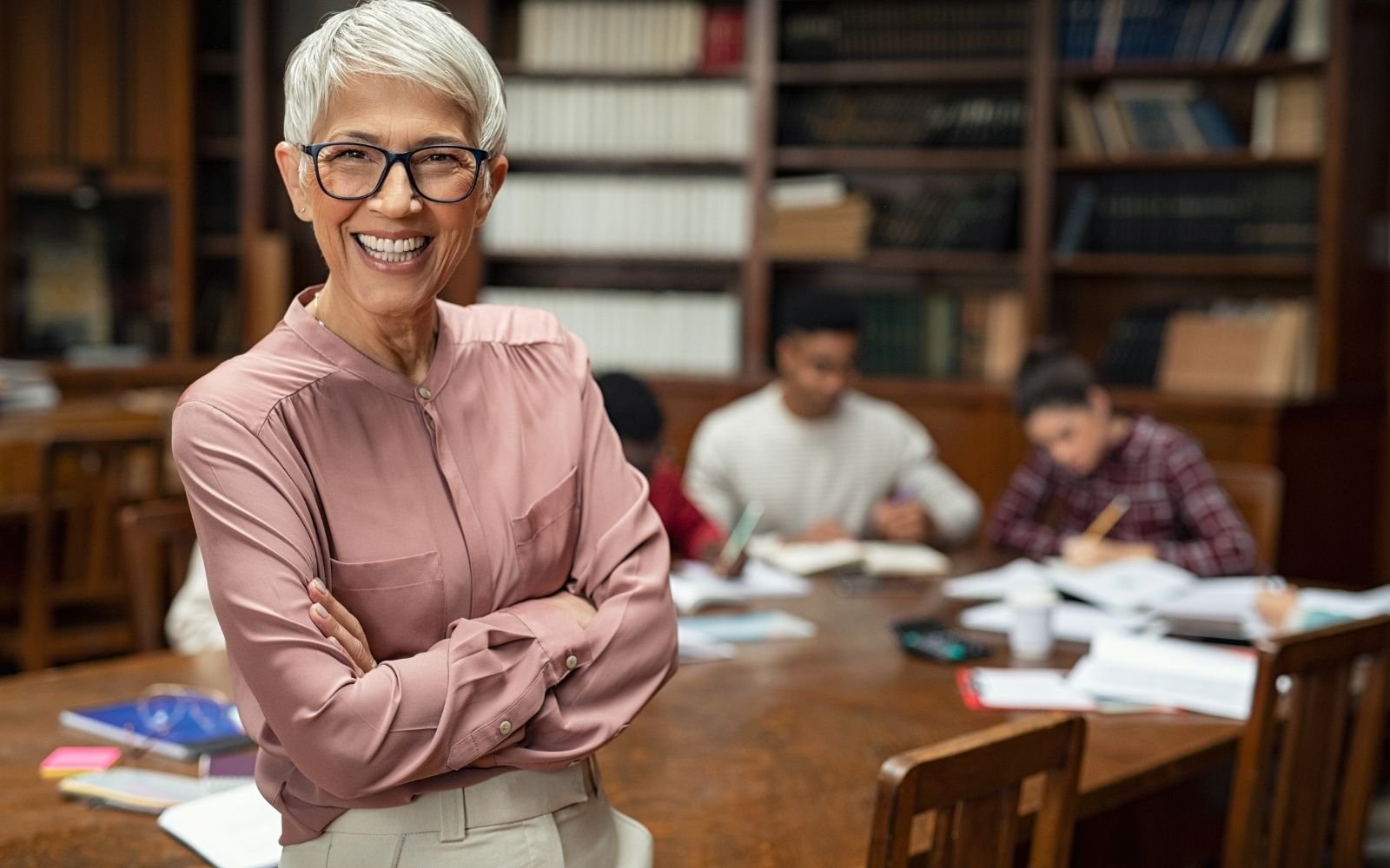 Teacher standing in front of students working