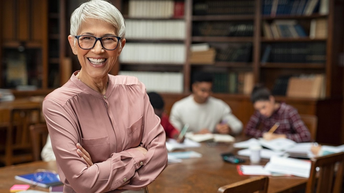 Teacher standing in front of students working