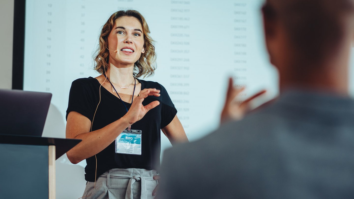 Woman giving a lecture to a group of people