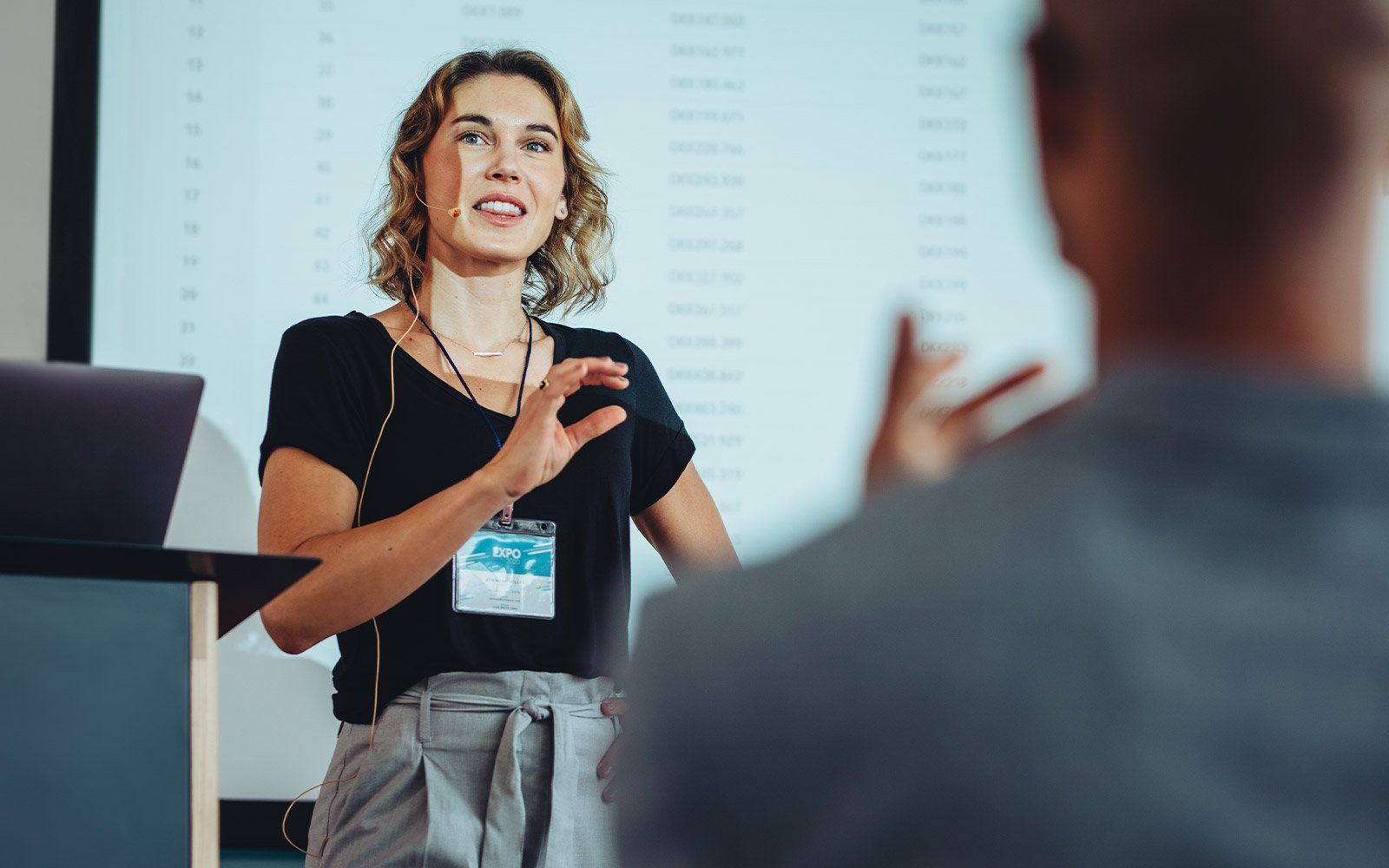 Woman giving a lecture to a group of people