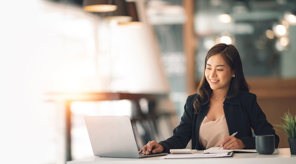 Professional woman in office on laptop