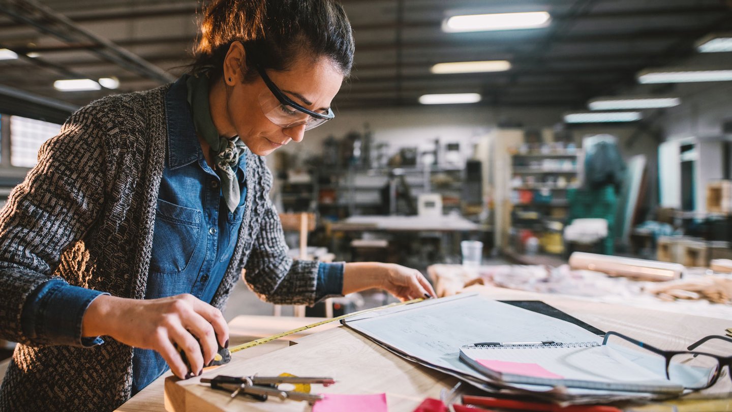 Woman in a workshop building construction model