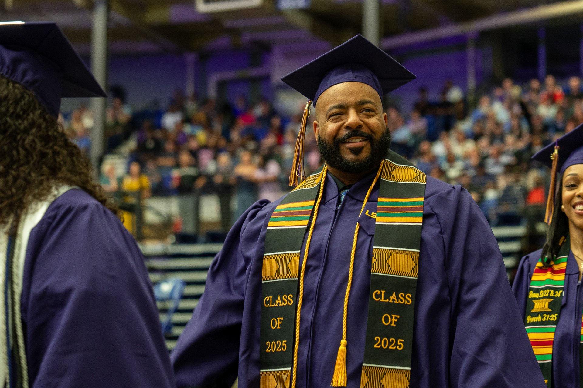 LSUA grad walking in line with other grads.