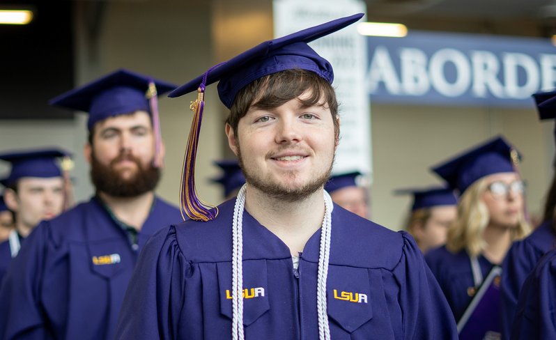 LSUA grad smiling at camera.