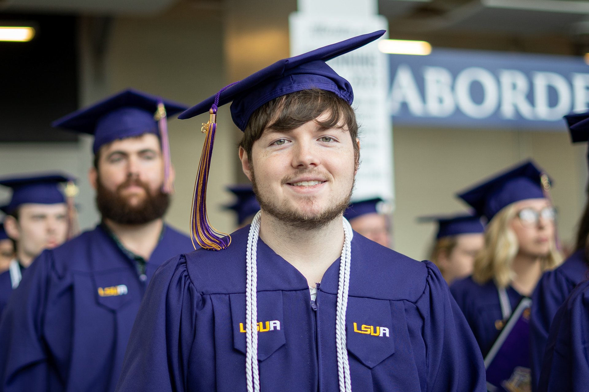 LSUA grad smiling at camera.