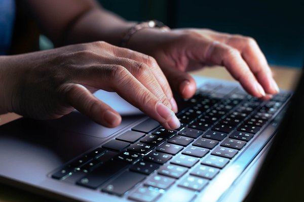 Hands typing on keyboard