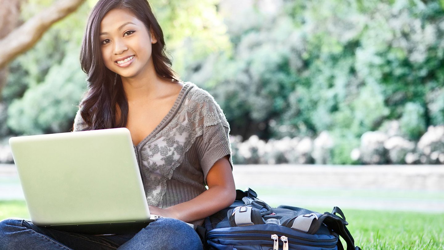Woman in park with her laptop