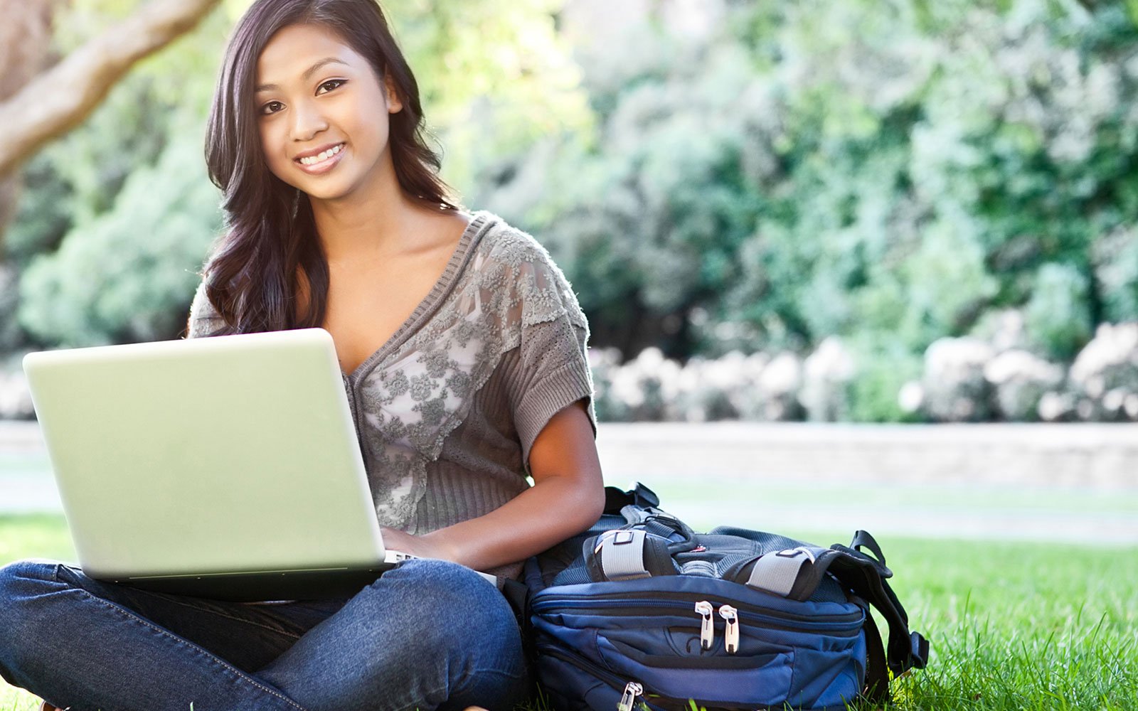 Woman in park with her laptop