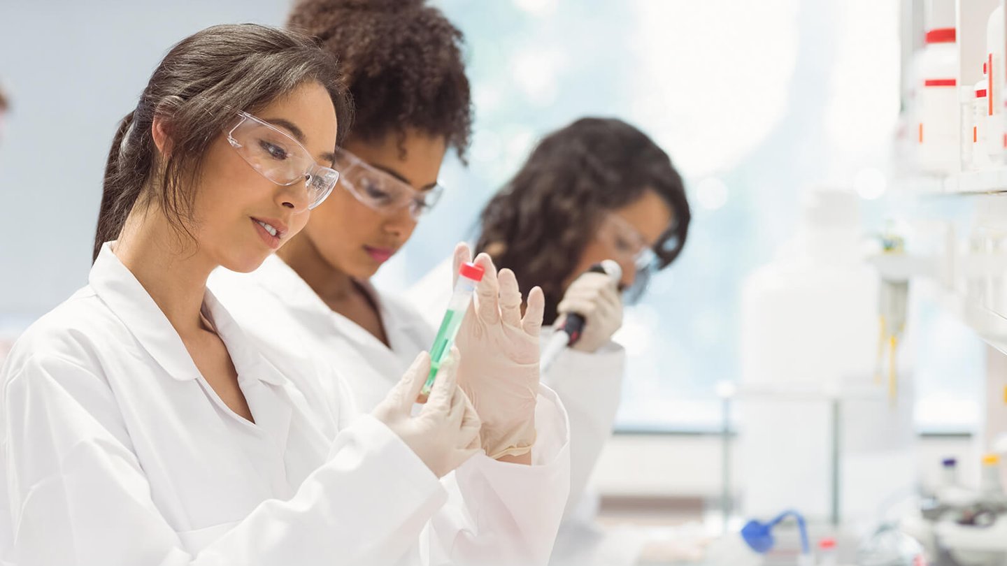 Lab workers looking at chemical