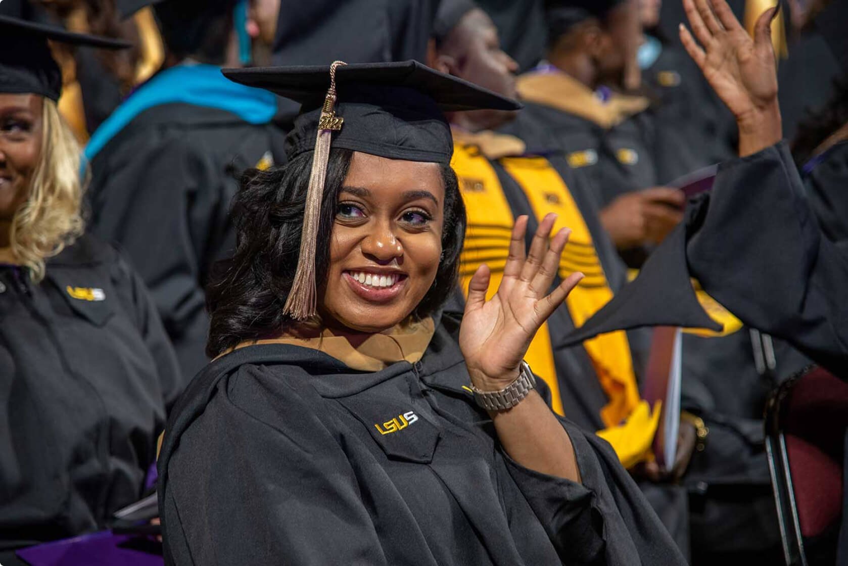 LSUS graduate waving