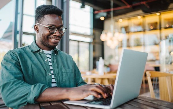 man on laptop at cafe