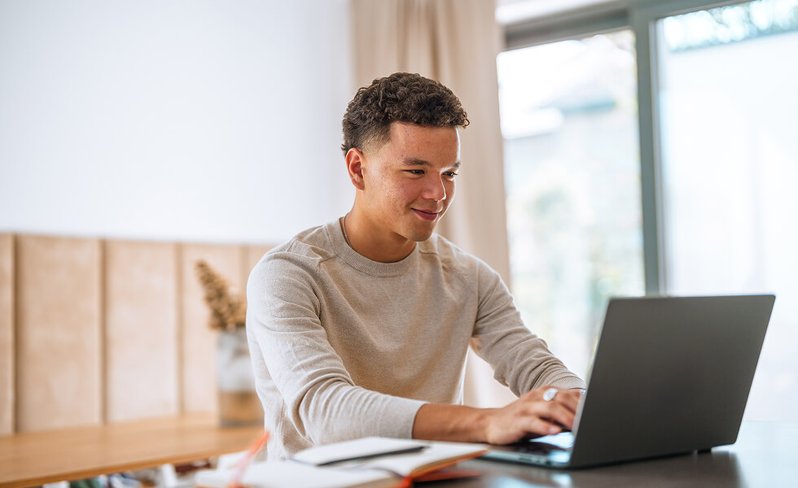 Student typing on laptop