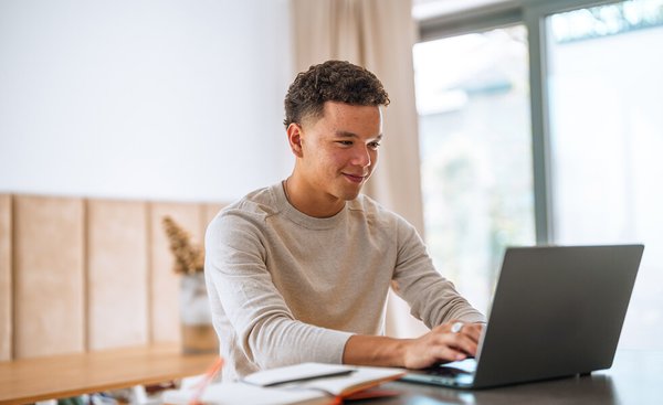 Student typing on laptop