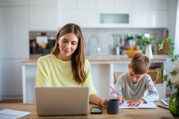 Mom learning online from her laptop in kitchen