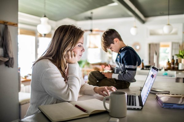 Mom working in kitchen on computer