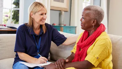 Two women talking and smiling at each other