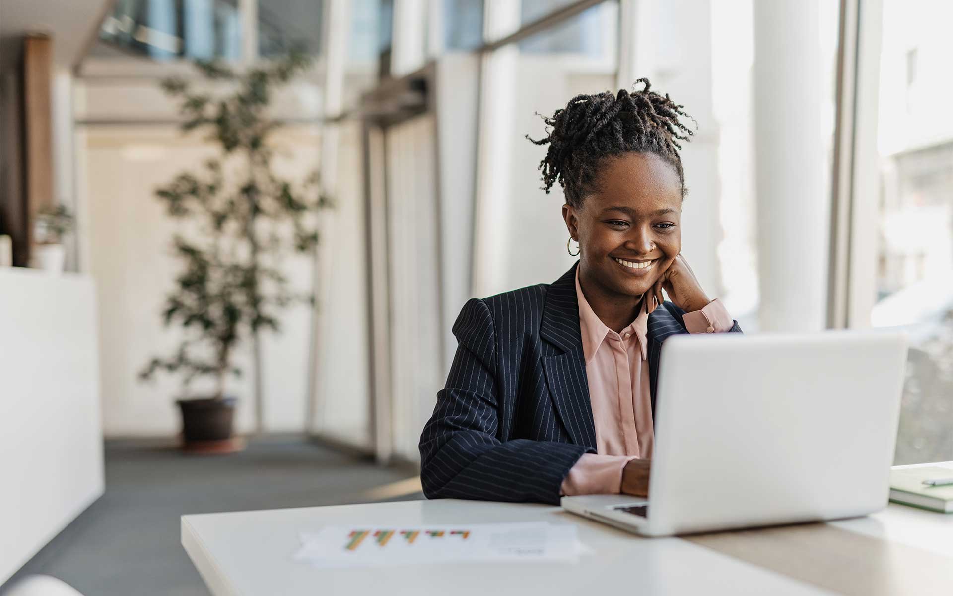 Professional woman using laptop at desk