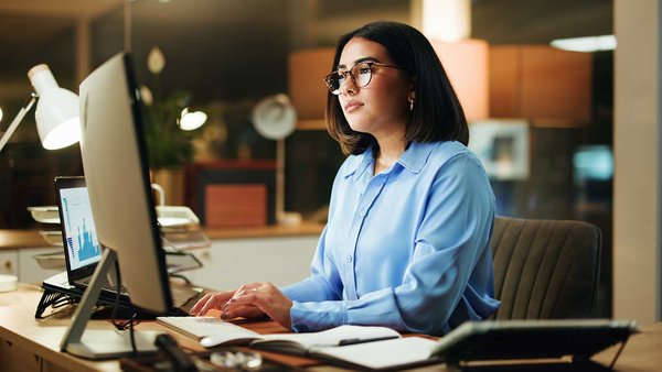 Professional woman typing on computer in office