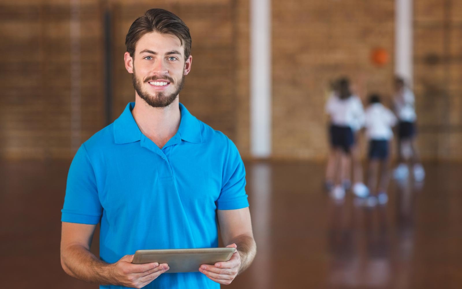 Coach standing in front of basketball team