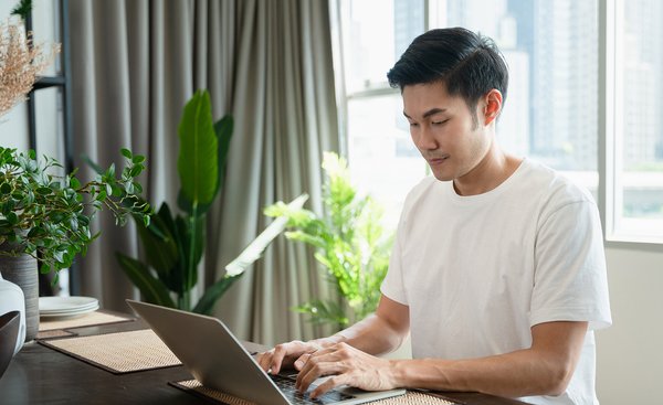 Male healthcare student on laptop