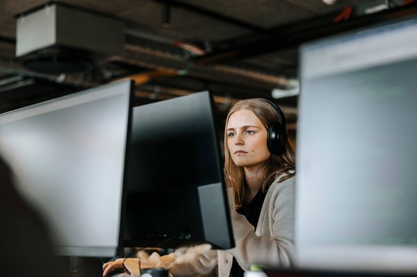 Student with headphones on computer