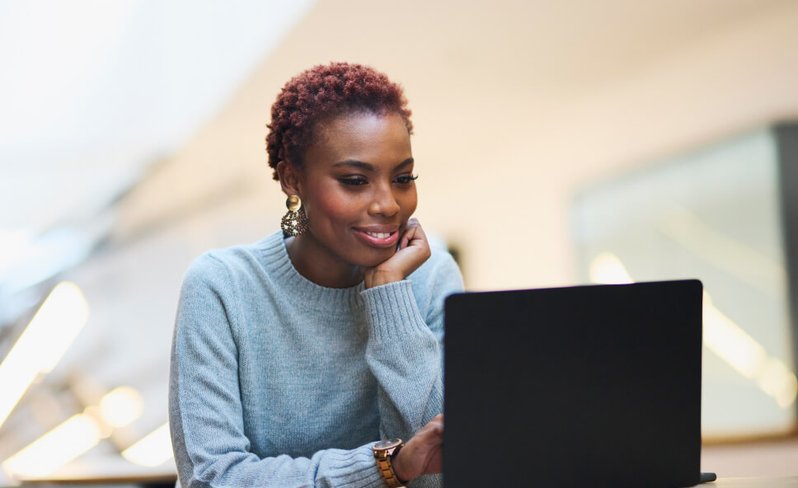 Woman using laptop at desk